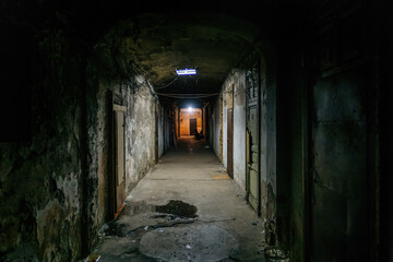 Fototapeta na wymiar Dark corridor of old shabby dorm or appartment house