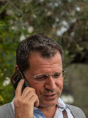 Middle-aged man talking on the phone