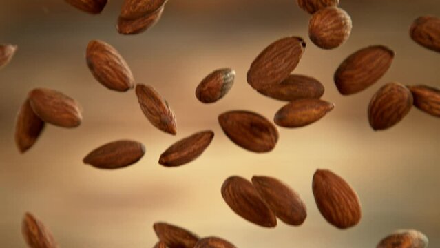 Falling of almonds, close-up, macro shot. Filmed on high speed cinematic camera at 1000 fps.