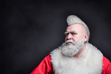 Brutal santa claus with mohawk. Freak santa wishes merry christmas and new year. Unusual crazy Christmas. Santa in the form of a harsh punk