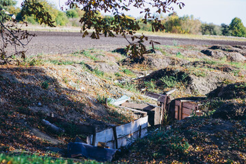 a trench in a field for soldiers - obrazy, fototapety, plakaty