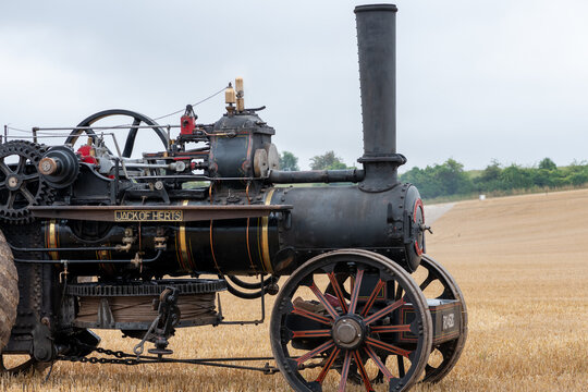 Side view of a restored Fowler K7 ploughing engine in a field