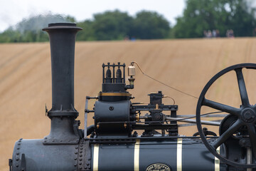 Close up of a steam powered ploughing engine in a field