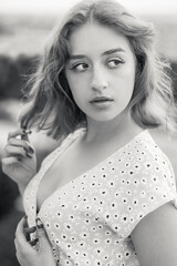 Close-up portrait of a stylish short-haired blonde at sunset. Black and white photo