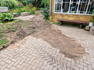Paved yard after water pipe repairs. Unfinished work.