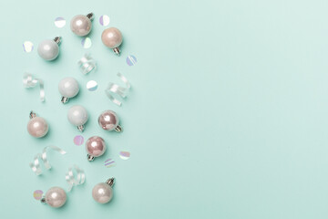Christmas balls on color background, top view