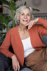 Obraz premium Portrait of a beautiful senior woman with short grey hair and lovely smile. Concept of attractive good looking elderly female, mature women with active lifestyle. Looking healthy and happy.