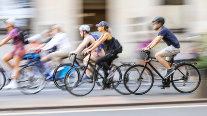 Blurred silhouettes of cyclists on a city street