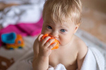 Baby chewing on a rubber toy - 537389857