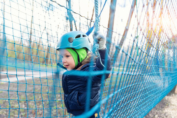 Portrait happy brave courage little toddler child boy wear safety equipment helmet enjoy passing...