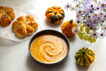 Pumkin soup with freshly baked bread roll