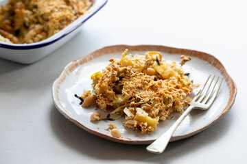 Vegan dish of parsnip, leek and bean crumble with crispy topping