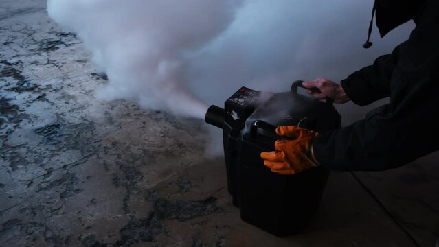 Smoke fog machine in action. The smoke machine releases a large cloud of smoke onto the stage