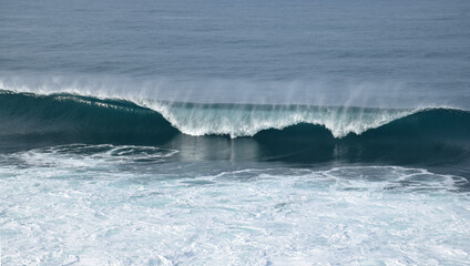 The waves crashing in the ocean, with a bluish tint at Drini Beach, Gunungkidul, Yogyakarta