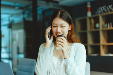 Make a phone call, Beautiful young Asian businesswoman working at workspace.