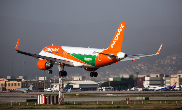 BARCELONA, SPAIN - JANUARY 24, 2020: Passenger OE-IVT Airbus A320 in special Europcar livery of British low-cost airline easyJet landing in International El Prat Airport in Barcelona