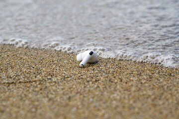 Wireless earphones falls into the ocean.