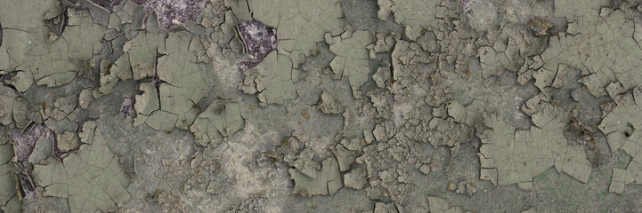 Peeling paint on the wall. Panorama of a concrete wall with old cracked flaking paint. Weathered...