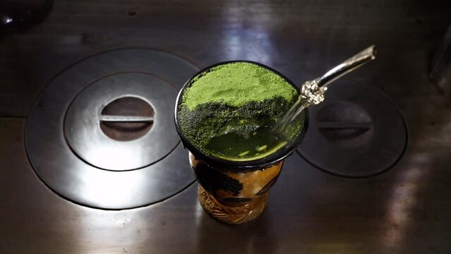 Traditional drink from southern Brazil. Putting hot water in the chimarr&atilde;o gourd (Cuia). Cuia de chimarr&atilde;o (Mate) 