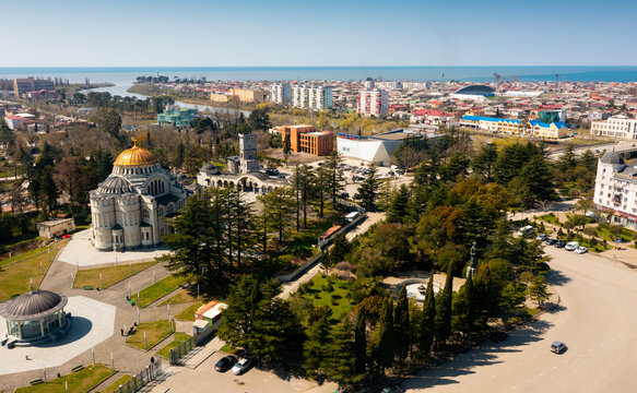 Scenic aerial view of Black Sea coastal city of Poti on banks of Rioni river overlooking golden domed Orthodox Cathedral on sunny spring day, Georgia.
