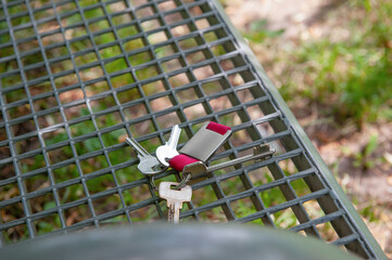 Keys forgotten on metal bench outdoors. Lost and found