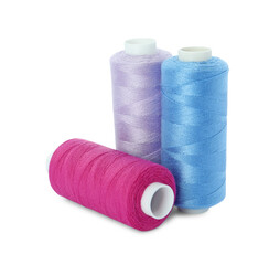 Different colorful sewing threads on white background