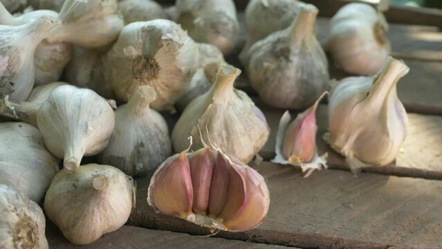 Fresh eco garlic bulbs on wooden background. Healthy food. Shopping food supermarket. Spicy culinary ingredient, healthy eating. Raw rustic vegetable
