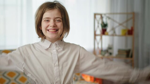 Cheerful girl celebrating success at home