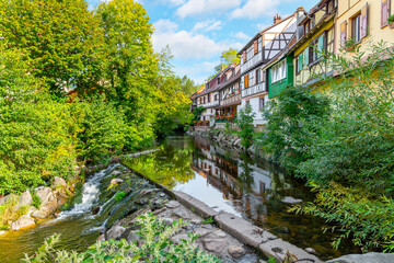 Half timbered medieval homes line the Weiss river canal in the historic town center of Kaysersberg, France in the Alsace region. 