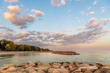 Sunset at Balmy Beach with people on the rocks and boardwalk watching the change of light.   Shot...