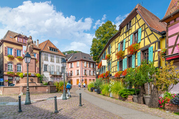 One of the many picturesque and colorful streets and alleys of half-timbered buildings in the medieval village of Ribeauville, France, in the Alsace wine region of France at Place de la Sinne Square.