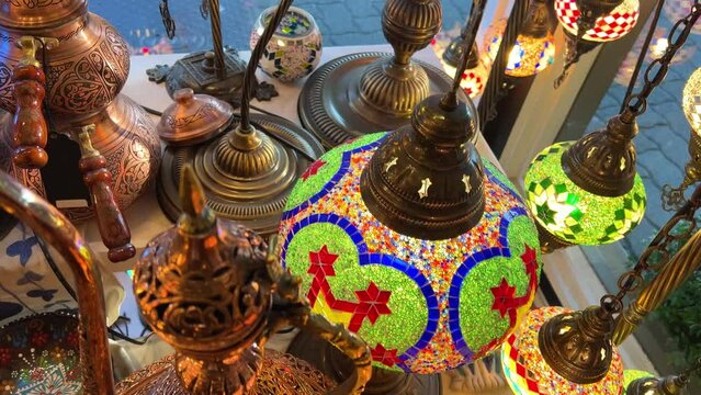 Turkish lamps have a multi-colored mosaic on them, they glow from the middle, shining and shimmering Nearby are Aladdin's lamps, various painted plates. The shop is lovely Showcase of vintage Turkish