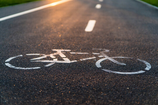 Bike Path With Sunset Sun, Bicycle Sign On Asphalt