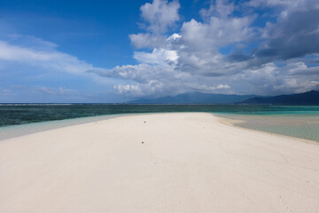 Remote uninhabited sandbar island with beautiful white sand surrounded by crystal clear ocean water...