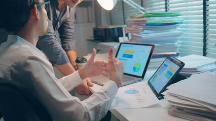 Close up of Asian two businessman using tablet computer work in office.