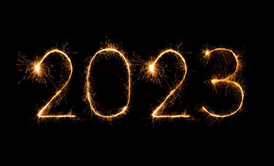 Obraz na płótnie Canvas 2023 happy new year fireworks celebration written sparkling at night.