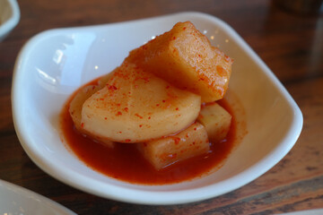 Kimchi made from radish served on a white plate