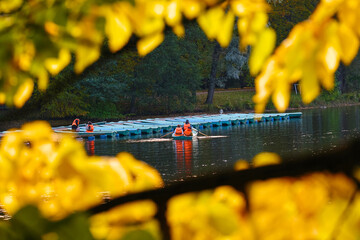 People ride in rented boats on the lake. Outdoor activities in autumn. Boat station.