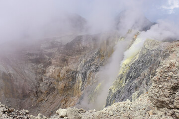 Plumes of sulphuric smoke from the volcanic crater of active volcano, Mount Balbi in remote tropics...
