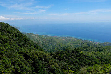 View of blue ocean and green tree covered hills and mountain landscape from Mount Manucoco on Atauro Island, Timor Leste, Southeast Asia