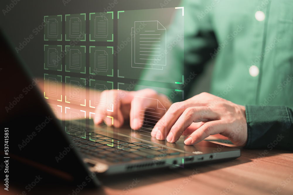 Aufkleber Document Management System (DMS), online documentation database and process automation to efficiently manage files. Corporate business technology. Employee man using a computer laptop in office.