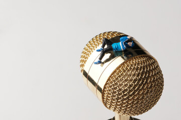 miniature of a man playing cellphone while lying down, wasting time concept
