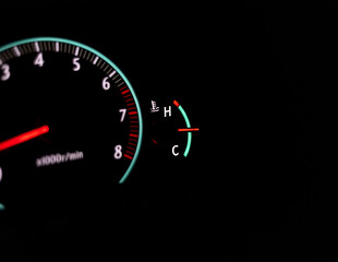 Fototapeta premium Car speedometer with a selective focus on a temperature gauge and blur background