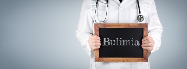 Bulimia nervosa. Doctor shows term on a wooden sign.
