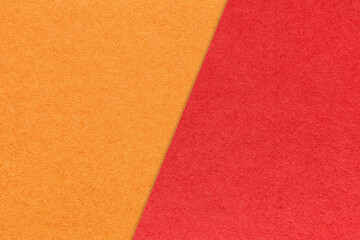 Texture of craft bright orange and red paper background, half two colors, macro. Vintage ruby and ginger cardboard.