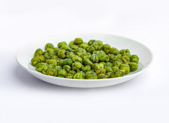 An image isolated close-up selected focus green peas bean on bowl ceramic white the food is a snack salty taste fried crunchy on the white background.