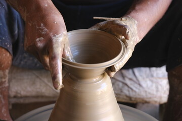 Fototapeta na wymiar 9 October 2022, Pune, India, Indian potter making Diya (oil lamps) or earthen lamps for Diwali Festival with clay, Handwork craft.