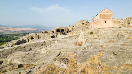 Archaeological site with the remains of a rock-cut settlement dating back to the Iron Age.