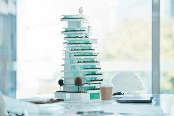 Architecture, model and mockup design of a 3d miniature future building on a table in office....