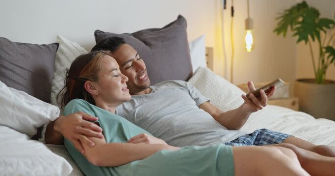 Happy couple, bedroom selfie and laughing at funny mobile pictures for social media, love and relaxing together at home. Smile man, young woman and taking phone photos of joy, comedy and lifestyle